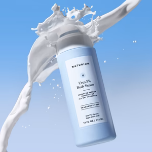 Naturium Urea 5% Body Serum bottle standing on a neutral surface – lightweight, fragrance-free body treatment for rough, dry skin and keratosis pilaris