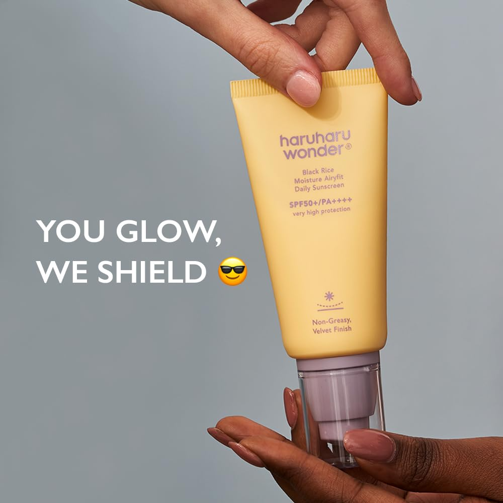Hand holding the yellow sunscreen tube with caption you glow we shield