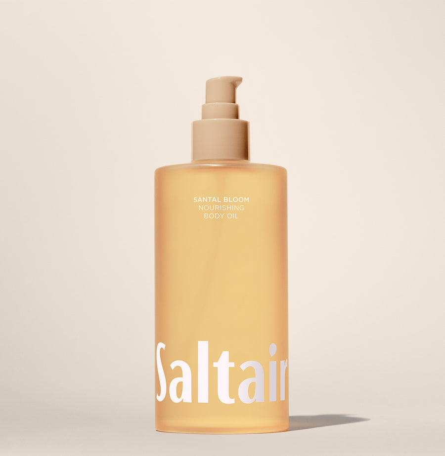 Saltair Santal Bloom Nourishing Body Oil bottle standing on a beige background.”