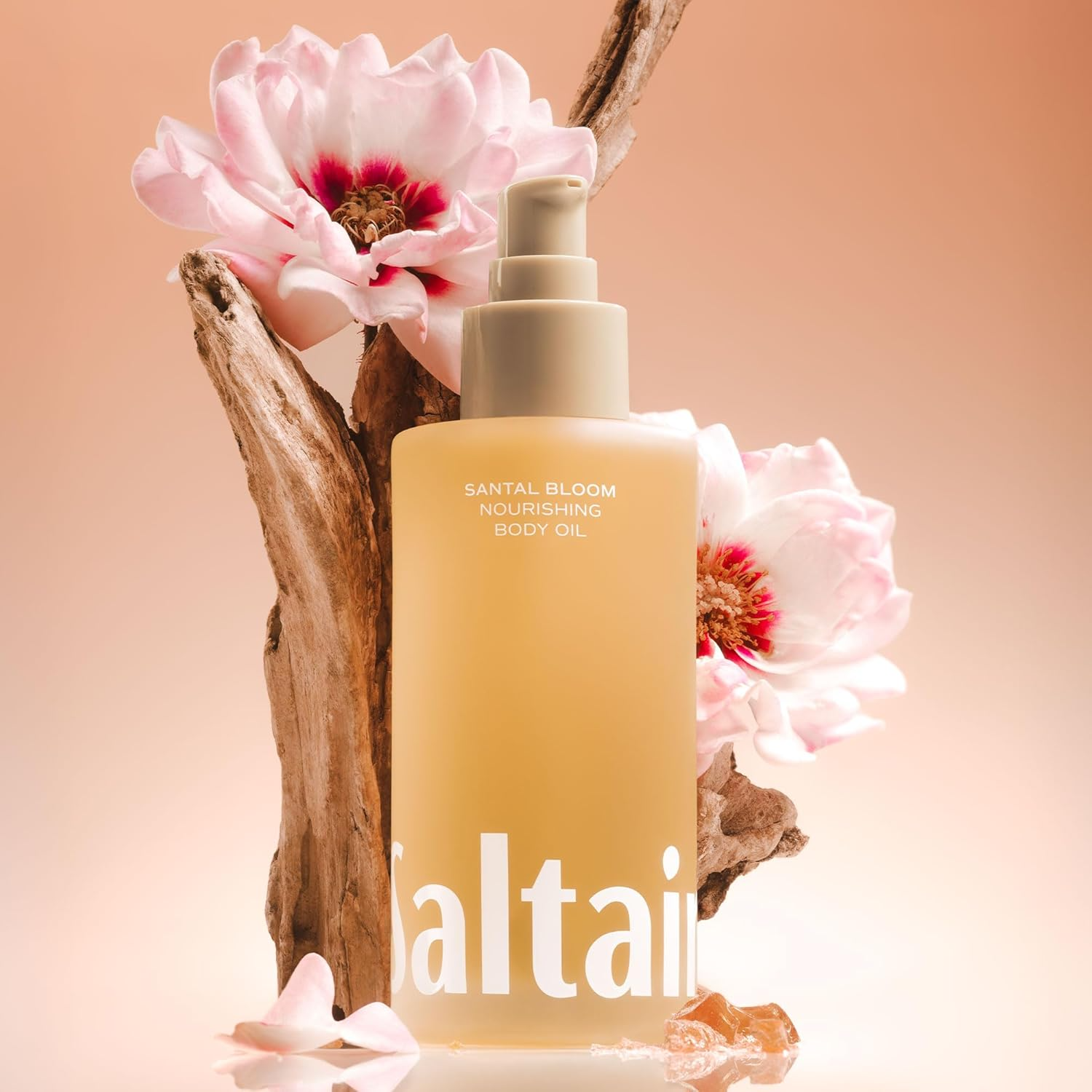 Saltair Santal Bloom Nourishing Body Oil bottle with flowers showing benefits for hydration, nourishment, and glow.