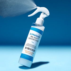 Dr.Melaxin Peel Shot Exfoliating TX Spray bottle with tranexamic acid and niacinamide on blue background