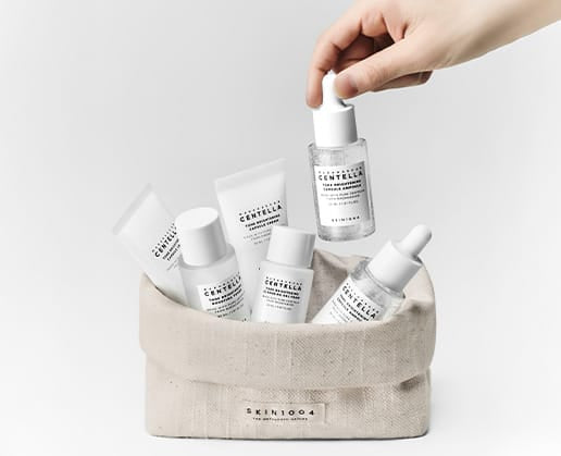 SKIN1004 Tone Brightening Travel Kit products displayed inside a linen storage pouch